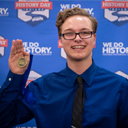 Kanin Bender holds up his National History Day in Indiana medal.