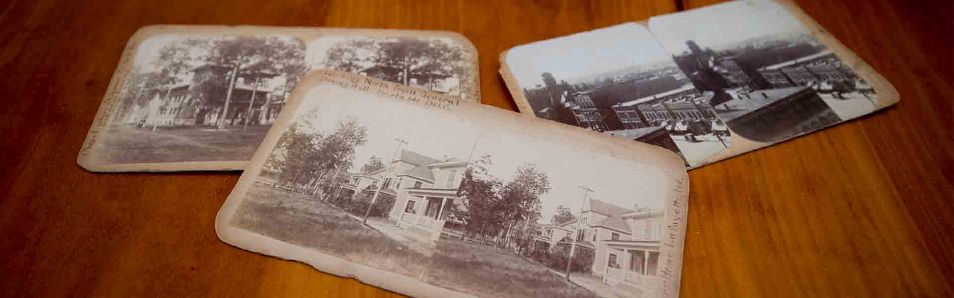 Three old postcards on table
