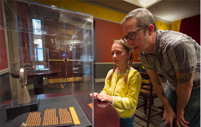 Father and daughter look at Cole Porter's Tony Award in the Cole Porter Room at the History Center.