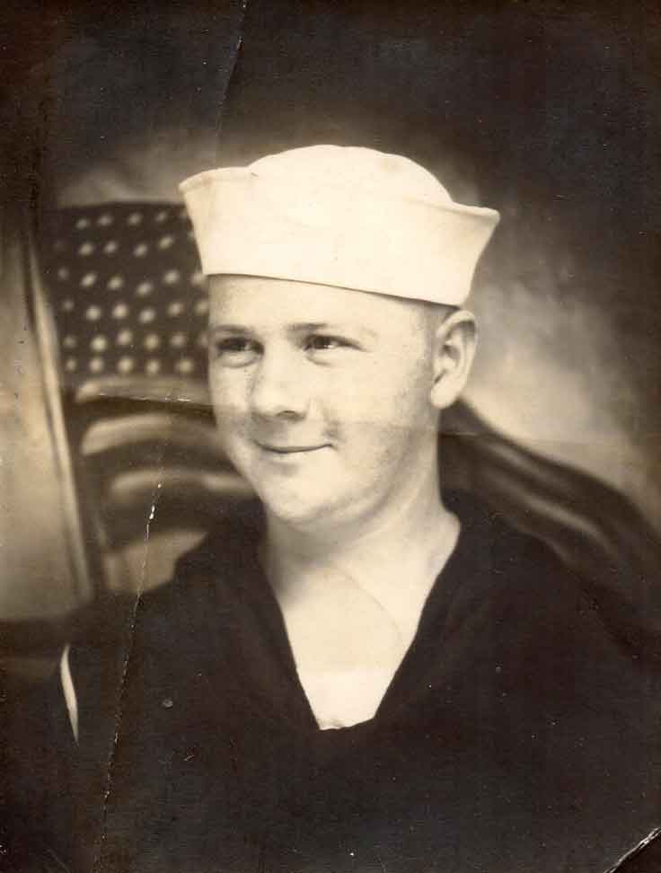 A sailor in the U.S. Navy blows a kiss following a ceremony in