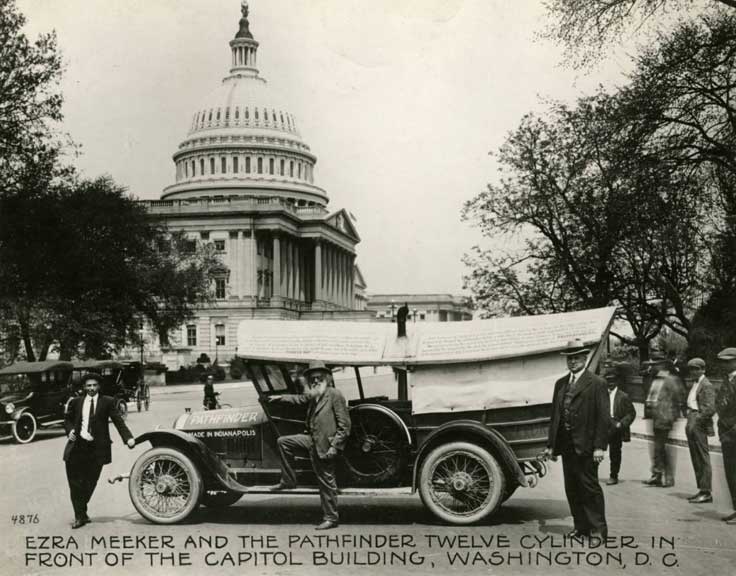 Ezra Meeker, American pioneer, posing with a Pathfinder Twelve Cylinder, built in Indianapolis, with a covered wagon-style top at the U.S. Capitol in Washington, D.C.