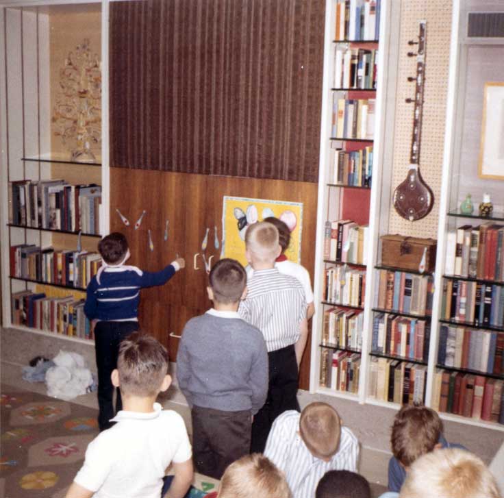 Boys playing pin the tail on the donkey.